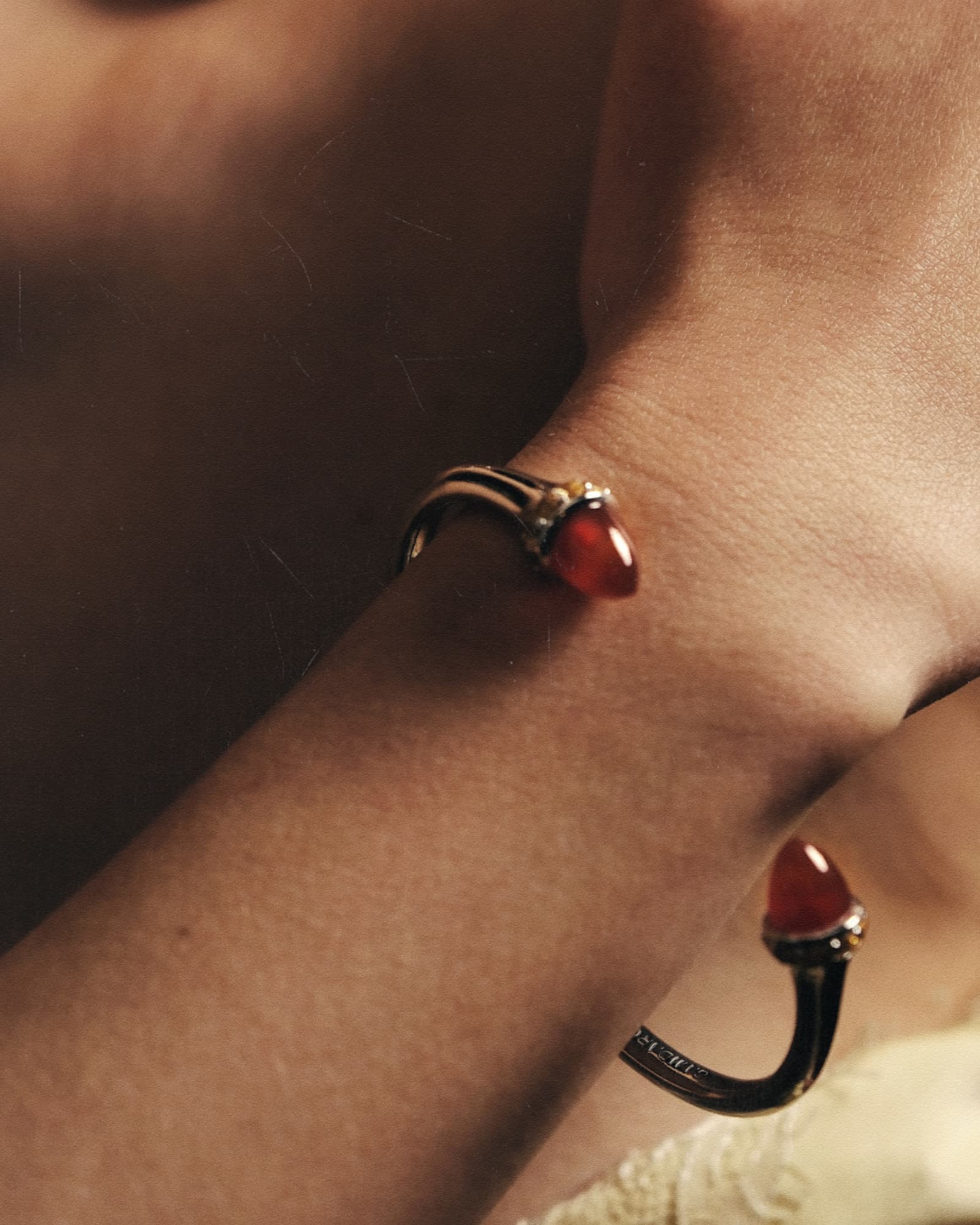 Close-up of a wrist wearing a red and black bracelet.
