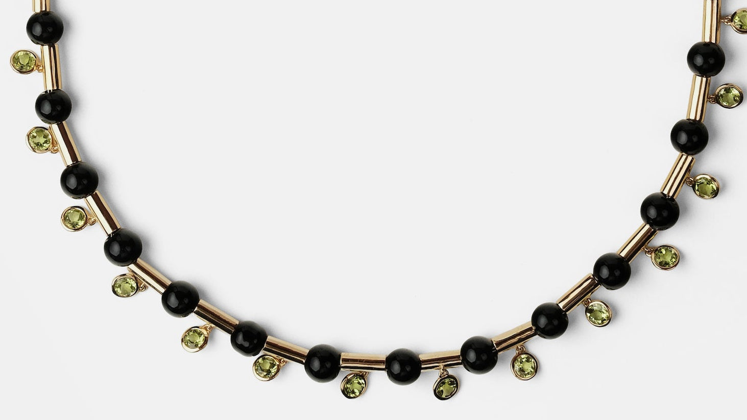 Necklace with black and gold beads on a white background