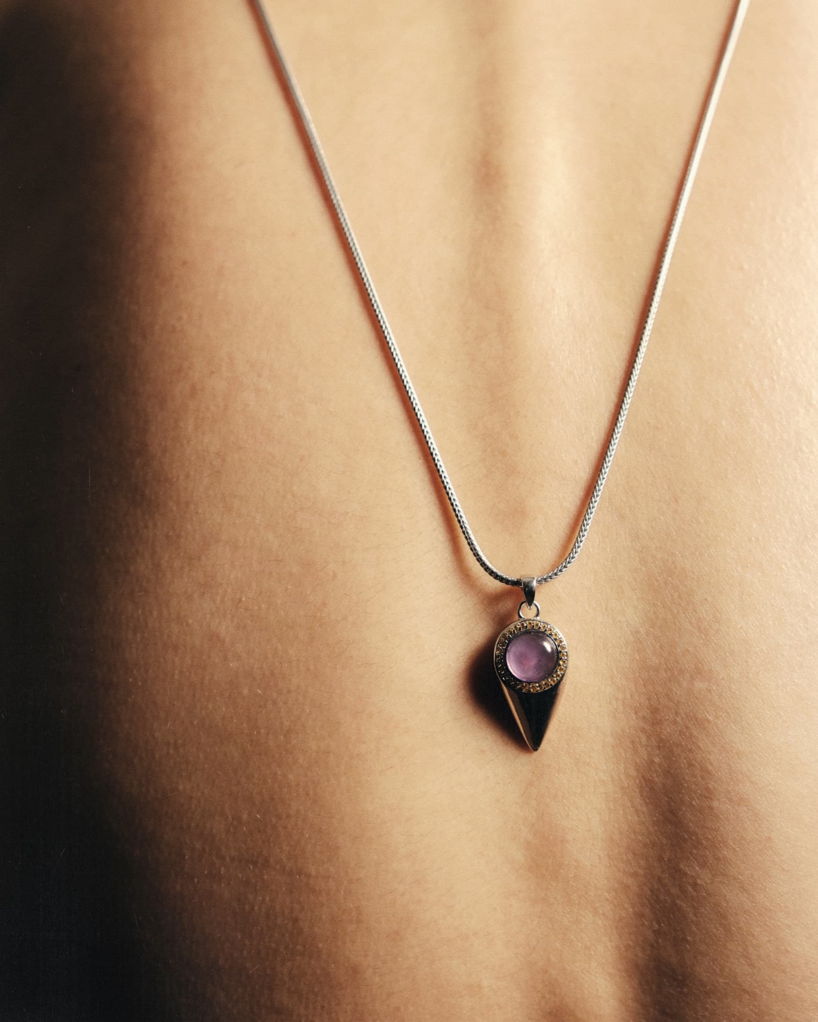 Necklace with a pendant on a person's neck